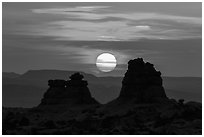 Sun setting between rock towers. Arches National Park, Utah, USA. (black and white)