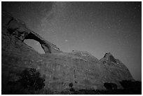 Skyline Arch at night with starry sky. Arches National Park, Utah, USA. (black and white)