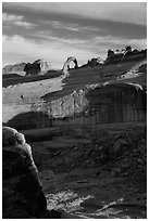 Delicate Arch atop steep cliff. Arches National Park, Utah, USA. (black and white)