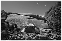 Tent with prayer flags amongst sandstone rocks. Arches National Park, Utah, USA. (black and white)