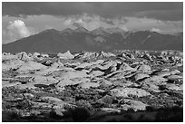 Petrified dunes and cloudy La Sal mountains. Arches National Park, Utah, USA. (black and white)