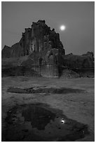 Courthouse tower and moon at night. Arches National Park, Utah, USA. (black and white)