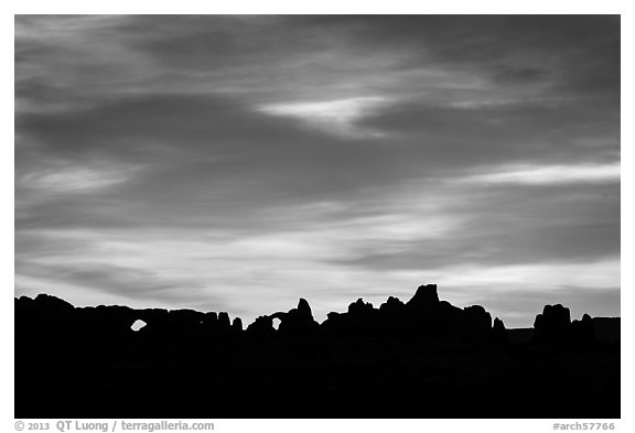 Windows and Turret Arch silhouetted at sunrise. Arches National Park (black and white)