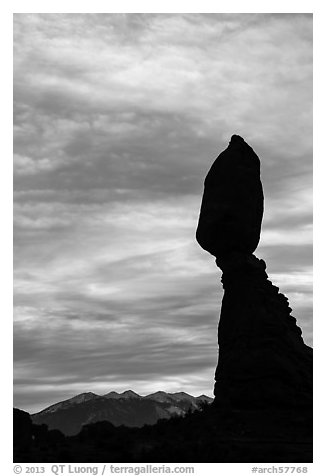 Balanced Rock silhouetted against La Sal Mountains and sky. Arches National Park (black and white)