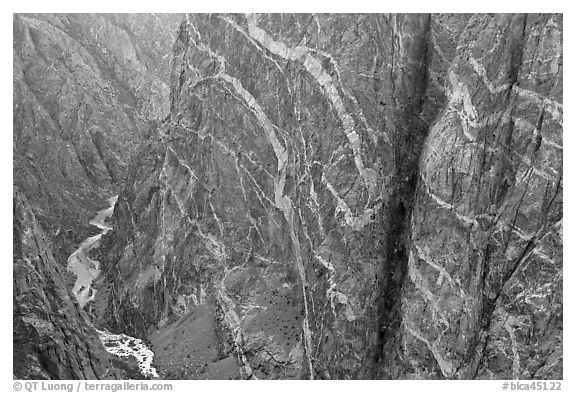 Stripes of pink and white crystalline pegmatite on rock wall. Black Canyon of the Gunnison National Park (black and white)