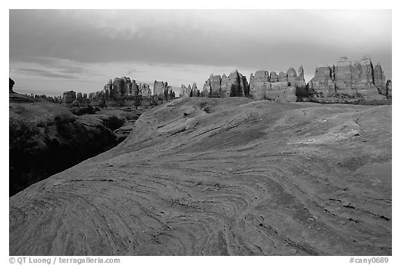 Sandstone swirls and Needles near Elephant Hill, sunset. Canyonlands National Park, Utah, USA.