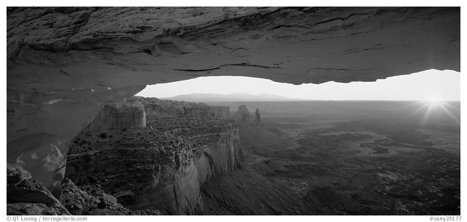 Sunrise and canyon landscape through Mesa Arch. Canyonlands National Park (black and white)