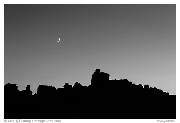 Crescent moon at sunset and Doll House spires. Canyonlands National Park (black and white)