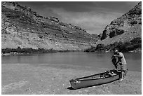 Canoeist and canoe near Confluence. Canyonlands National Park, Utah, USA. (black and white)