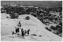 Hikers on Whale Rock. Canyonlands National Park, Utah, USA. (black and white)