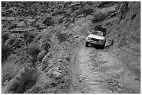 High clearance four-wheel-drive vehicle on the Flint Trail,  Orange Cliffs Unit,  Glen Canyon National Recreation Area, Utah. USA (black and white)