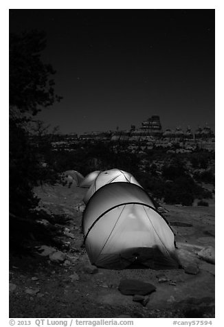 Lit tents at night in the Dollhouse. Canyonlands National Park, Utah, USA.