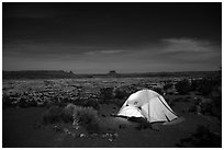 Tent overlooking the Maze at night. Canyonlands National Park, Utah, USA. (black and white)