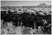 Hikers on Petes Mesa ridge above the Maze. Canyonlands National Park, Utah, USA. (black and white)