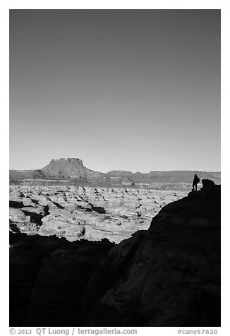 Hiker standing in silhouette above the Maze. Canyonlands National Park, Utah, USA.