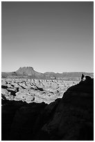 Hiker standing in silhouette above the Maze. Canyonlands National Park, Utah, USA. (black and white)