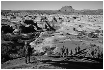 Group hiking down into the Maze. Canyonlands National Park, Utah, USA. (black and white)