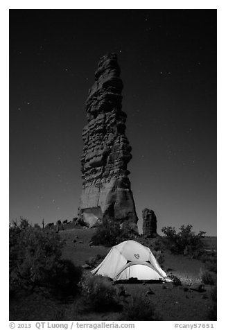 Tent at the base of Standing Rock at night. Canyonlands National Park, Utah, USA.