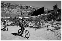 Mountain bikers in Teapot Canyon, Maze District. Canyonlands National Park, Utah, USA. (black and white)