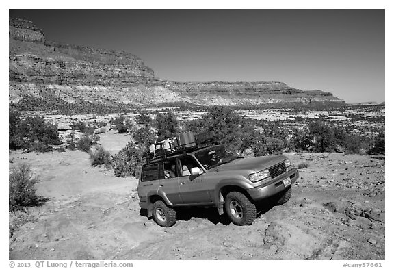 4WD vehicle driving over rocks in Teapot Canyon. Canyonlands National Park (black and white)