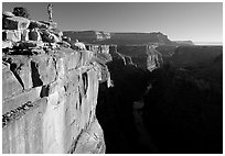 Hiker looking down into  Grand Canyon at Toroweap, early morning. Grand Canyon National Park, Arizona, USA. (black and white)