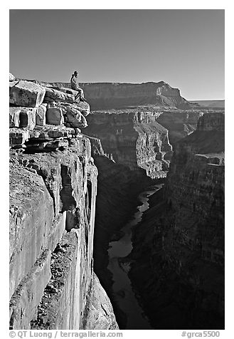Visitor sitting on  edge of  Grand Canyon, Toroweap. Grand Canyon National Park (black and white)