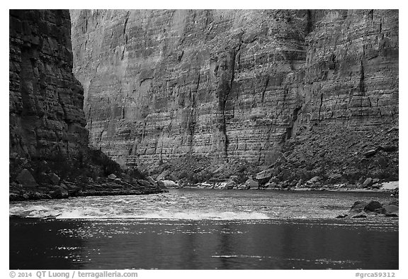 Glassy river and rapids below Redwall limestone canyon walls. Grand Canyon National Park (black and white)