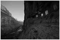 Ancient Nankoweap granaries with windows lit and Colorado River at dusk. Grand Canyon National Park ( black and white)