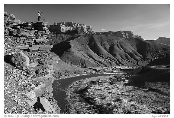 Photographer on steep cliff above Unkar rapids. Grand Canyon National Park (black and white)