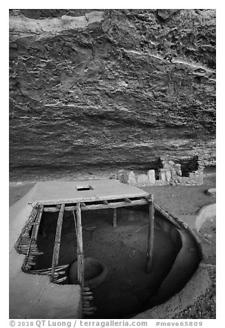 Reconstructed pithouse and original walls below rock roof, Step House. Mesa Verde National Park (black and white)