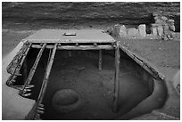 Reconstructed Basketmaker pithouse in Step House. Mesa Verde National Park ( black and white)