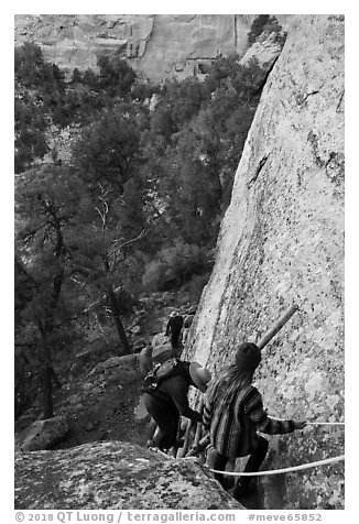 Tour participants negotiate cliff. Mesa Verde National Park (black and white)