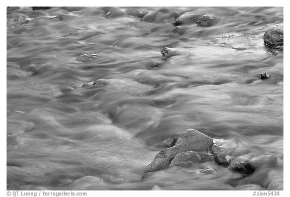 Water flowing in the Virgin River, with reflections from cliffs. Zion National Park, Utah, USA.