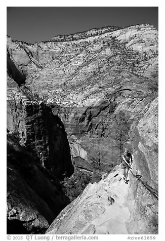 Woman hiker clinging to cable on Hidden Canyon trail. Zion National Park (black and white)