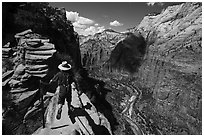 Hiker stepping next to sheer cliff, Angels Landing. Zion National Park ( black and white)