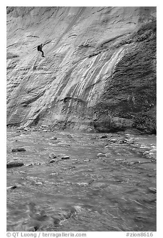 Canyoneer rappelling alongside Mystery Falls, the Narrows. Zion National Park, Utah, USA.