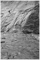 Canyoneer rappelling alongside Mystery Falls, the Narrows. Zion National Park, Utah, USA. (black and white)