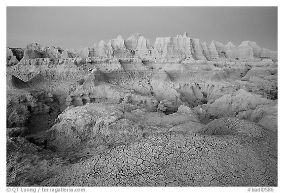 Cracked mud and erosion formations, Cedar Pass, dawn. Badlands National Park, South Dakota, USA.