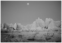 Moon and eroded badlands, Cedar Pass, dawn. Badlands National Park, South Dakota, USA. (black and white)