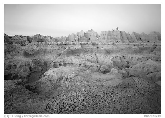 Cracked mudstone and eroded towers near Cedar Pass, dawn. Badlands National Park, South Dakota, USA.