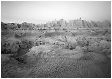 Cracked mudstone and eroded towers near Cedar Pass, dawn. Badlands National Park ( black and white)