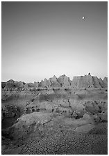 Mud cracks, badlands, and moon at dawn. Badlands National Park ( black and white)