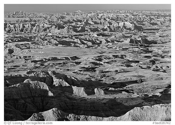 Prairie and eroded ridges stretching to horizon, early morning. Badlands National Park (black and white)