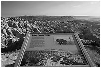 Interpretative sign, Sage Creek badlands. Badlands National Park, South Dakota, USA. (black and white)