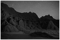 Badlands and star trails. Badlands National Park, South Dakota, USA. (black and white)