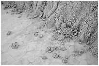 Base of butte with mudstone rolling onto flat soil. Badlands National Park ( black and white)