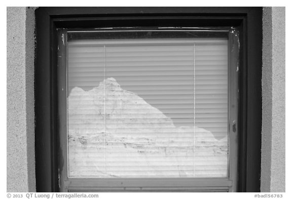 Butte, Window reflexion, Badlands National Park Headquarters. Badlands National Park, South Dakota, USA.