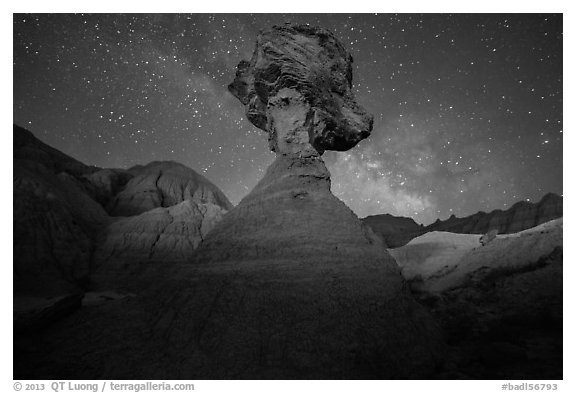 Pillar with caprock, badlands, and Milky Way. Badlands National Park, South Dakota, USA.