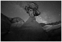 Pillar with caprock, badlands, and Milky Way. Badlands National Park, South Dakota, USA. (black and white)