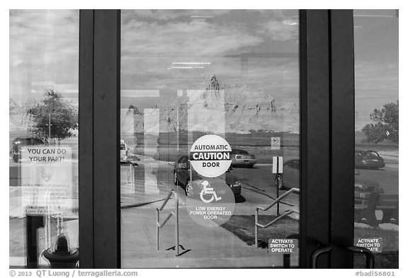 Buttes, Ben Reifel Visitor Center window reflexion. Badlands National Park, South Dakota, USA.